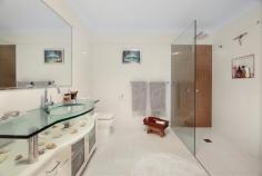 64 Fenton Drive Tallebudgera QLD 4228 $1,799,000 Situated on a sprawling 5,083m² block, this expansive six-bedroom, three-bathroom residence has almost 600m² of living and entertaining space - perfect for big families or multi-generational households. Wrapped in greenery and elevated to capture a stunning treetop outlook, this dual-level home blends lifestyle and liveability with ease. Two luxurious master suites, multiple indoor-outdoor living areas, a gourmet kitchen and an extra-large double garage with workshop are just a few of the standout features that make this private retreat truly exceptional. The double door entry opens wide to polished timber floors and high ceilings delivering a welcoming ambience and glimpse of the inviting leafy outlook. Move with ease through open plan living, dining and family zones onto a massive wraparound deck and covered alfresco area - ideal for relaxing or entertaining. Well-appointed with gas cooking and freestanding range, the kitchen also has durable stone benchtops and abundant storage including a large corner pantry. The spacious upstairs master suite has private balcony access, an oversized walk-in robe and the indulgent ensuite has both spa bath and rainfall shower. Also on this level four generously sized bedrooms accompany a home office (or seventh bedroom) and the main bathroom has a floating timber vanity and walk-in shower. Downstairs is designed for versatile dual living, a second master with ensuite, an additional bedroom and a vast second living/rumpus area - all with access to covered balconies. This level is ideal for independent teens, guest accommodation or extended family. Further features include a large laundry with drying court, ducted air-conditioning, an Enviro system, solar panels and extensive storage areas including an internal 2.3x5m room. Located in sought-after Tallebudgera, this tranquil retreat offers a superb balance of privacy and convenience. Families will love the proximity to top local schools, while stunning beaches, vibrant Burleigh Heads and lifestyle hubs are all just minutes away. With Gold Coast Airport under 20 minutes from your door and Surfers Paradise under 30, this property is perfectly positioned for both relaxed living and easy coastal access. Main Features: Stunning dual level home with gleaming timber floors and high ceilings Elevated bushland setting enhances an expansive 589m² floorplan of indoor/outdoor living 6 spacious bedrooms, office (or 7th bedroom) plus 3 bathrooms 2 master suites each with walk-in robes and ensuites Upstairs master with spa ensuite, rainfall shower and private access to balcony Multiple areas include formal and informal living Covered alfresco and wraparound balconies with leafy outlook Kitchen with gas cooking, stone benchtops and large pantry adjoins everyday living area Large laundry with stone bench and adjacent drying court Ducted air-conditioning and ceiling fans Other features: 5083 block with private bushland backdrop Abundant storage – 2 linen cupboards, 2 cupboards (1 measuring 2.3mx5m), under house storage Over-sized double garage with workshop space 1.5kW Solar system with a 2kW inverter Enviro cycle system Chicken coop Location: Approx. 4 mins to St. Andrew's Lutheran College Approx. 5 mins to Tallebudgera State School Approx. 8 mins to Burleigh Heads Approx. 10 mins to Palm Beach Approx. 15 mins to Currumbin Alley Approx. 17 mins to Gold Coast Airport Approx. 29 mins to Surfers Paradise