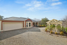 6 Sovereign Ct Mount Barker SA 5251 $1,600,000 - $1,700,000 Waterford Sanctuary: Federation Charm, Workshop Shed, and 1.13 Acres of Pure Lifestyle There are properties that offer a house on a block, and then there are properties that offer a whole way of life. This 2003 McCracken Homes Federation-style build on 1.13 acres in the sought-after Waterford precinct is firmly in the second category. From the drive-through motorhome access and three-phase workshop shed to the established orchard and 45,000-litre rainwater system plumbed through the home, every corner of this cul-de-sac holding has been developed with intention, and it shows. Inside, nine-foot ceilings and quality solid timber internal doors set a tone that carries from the formal living room through to the rear of the home. The formal living space features timber flooring and a Nectre slow-combustion wood heater, while the separate formal dining room anchors itself with a bay window overlooking the gardens. The kitchen is a proper working hub, with an island bench, walk-in pantry, and a new Bosch dishwasher, opening through to the meals and family living area where a second Nectre wood heater and split-system air conditioning make year-round comfort effortless. Ducted evaporative cooling runs throughout the whole house, and new LED fittings have replaced every halogen across the property. The raised timber deck and large pitched-roof pergola entertaining area is where the Adelaide Hills seasons really come alive. Morning coffee with orchard views across cherry, Fuji apple, Gala apple, nectarine, mulberry, lime, passionfruit, plum, lemon, orange, mandarin, almond, and more; summer evenings under the pergola with the garden doing the heavy lifting. Raised vegetable beds on mains water, automatic mains-fed drip irrigation to the garden, pine bark mulched bush-walk paths, and a garden shed with shelving round out a rear garden that is genuinely established and entirely usable. The master bedroom is generously proportioned with a walk-in robe and ensuite, while one further bedroom features a built-in robe. The fourth bedroom, currently a study but noted by agents as another big bedroom, adds real flexibility. The main bathroom delivers a twin vanity, spa bath, and separate shower, and new toilets have been fitted across both bathrooms. The shed is the headline act for anyone who works with their hands, runs a trades business, or needs serious vehicle storage. Three-phase power, a concrete floor, a vehicle inspection pit, an overhead crane with trolley and chain hoist, eight-tube LED lighting, security cameras, internet connectivity, and a mezzanine level with properly engineered structural flooring make this a workshop that means business. A manual 500kg chain hoist is also included. Drive-through access from the double garage accommodates a 7.9-metre motorhome or 20-foot caravan with ease, a rare find at this price point in the Hills. What you'll love: • Entertainer's Edge: Raised timber deck and large pitched-roof pergola entertaining area with established orchard views across fifteen-plus fruit and nut varieties. • Workshop Benchmark: Three-phase shed with concrete floor, inspection pit, overhead crane with trolley and chain hoist, mezzanine level, LED lighting, and drive-through caravan or motorhome access. • Water Independence: 45,000 litres of rainwater storage plumbed to the full house, including a dedicated 22,500 litres for rear garden irrigation. • Energy Efficiency: 9kW solar system split across house and shed roofs with internet-connected monitoring, solar hot water, plus dual Nectre slow-combustion heaters and ducted evaporative cooling. • Custom Character: Solid timber internal doors throughout and nine-foot ceilings across the whole home. • Connected Infrastructure: NBN fibre to the premises with data points, a patch panel, and structured cabling throughout. • Lifestyle Location: 1.13-acre cul-de-sac position in the Waterford precinct with established landscaping, bush-walk paths, and room to breathe. For the buyer who wants genuine land, a serious workshop, a productive garden, and a Federation-character home that has been upgraded thoughtfully over two decades, this Waterford holding is a rare and complete package. All information provided has been obtained from sources we believe to be accurate, however, we cannot guarantee the information is accurate and we accept no liability for any errors or omissions.