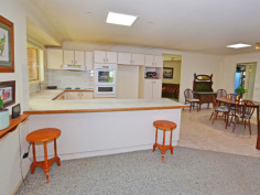 10A Main St Robertson NSW 2577 CENTRALLY LOCATED SPACIOUS HOME TO SUIT EVERYONE IN THE FAMILY ! First time on the market since built 1998, all the family will feel at home here with features to accomodate a myriad of interests. Set discreetly back from the street, the entrance portico opens out into a large formal living/dining room - or perhaps the 'parents' retreat. Step into the open plan kitchen, with long servery bench + loads of cupboards and adjacent informal dining area - or potential office spot - where the warmth of the enormous slow combustion fireplace will ensure the children are comfy in front of the wall mounted TV. The master bedroom with ensuite, walk-in-robe and bay window feature, is bathed in eastern light for your easy start to the morning. 3 other bedrooms are clustered around the main bathroom with separate shower & bath & completely separate toilet. For the gardener, the back yard boasts enclosed veggie beds ready to be rejuvenated and another fruit tree enclosure...with still plenty of room for outdoor entertaining under the covered nook just outside the kitchen windows or beside the large workshed/home hobbyist 'hideout'. Just the thing for a home gym, artist studio or 'kids' retreat' for peace and quiet. Many different varieties of flowering shrubs, amidst well established Tree Ferns, will delight all year round and add a layer of privacy to the perimeters. Other features include internal access to the double garage (which has a single roller door for access at the rear), internal laundry with external door to the clothes line, this home only needs 'your touch' for comfort and convenience for your family to grow in the community friendly atmosphere of Robertson village.