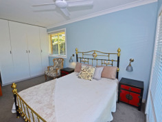 35 Shackleton St Robertson NSW 2577 PLENTY OF ROOM & PRIVATELY POSITIONED FAMILY HOME ON APPROX 1330SQM You'll only see the hedge rimmed drive into No 35 until the block opens out at the gateway to a wide fully fenced expanse - park the weekender van or tradie's truck within eyesight. The comfortable home is well sited with a large secure front yard for the children & pets to play safely and also offers access either side to the north facing rear garden. The entry hall leads into an open plan living, kitchen & dining area with loads of light through large windows north and south. The kitchen features a wide servery (or preparation) bench perfect for the quick brekkie or evening drinks whilst dinner is on the way with the dining table close by. The main bedroom is off to the right with a partial wall of robes to disguise the cutest ensuite. The western side of the home has a spacious 3-way main bathroom with 3 more bedrooms for the growing family. The internal laundry doubles as a butler's pantry with easy access outside. The very private rear garden is bathed in northern sun with a rural outlook towards the 5 acre lots that front onto Lemmons Road - not likely to be built out - and also features a 'guest shed' with high ceilings to living area, separate bedroom + ensuite. Beautifully styled and quite the retreat ! PRIVACY, SPACE & IN A QUIET PLACE...come see me.