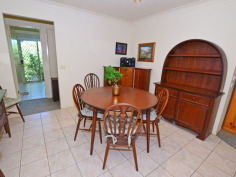10A Main St Robertson NSW 2577 CENTRALLY LOCATED SPACIOUS HOME TO SUIT EVERYONE IN THE FAMILY ! First time on the market since built 1998, all the family will feel at home here with features to accomodate a myriad of interests. Set discreetly back from the street, the entrance portico opens out into a large formal living/dining room - or perhaps the 'parents' retreat. Step into the open plan kitchen, with long servery bench + loads of cupboards and adjacent informal dining area - or potential office spot - where the warmth of the enormous slow combustion fireplace will ensure the children are comfy in front of the wall mounted TV. The master bedroom with ensuite, walk-in-robe and bay window feature, is bathed in eastern light for your easy start to the morning. 3 other bedrooms are clustered around the main bathroom with separate shower & bath & completely separate toilet. For the gardener, the back yard boasts enclosed veggie beds ready to be rejuvenated and another fruit tree enclosure...with still plenty of room for outdoor entertaining under the covered nook just outside the kitchen windows or beside the large workshed/home hobbyist 'hideout'. Just the thing for a home gym, artist studio or 'kids' retreat' for peace and quiet. Many different varieties of flowering shrubs, amidst well established Tree Ferns, will delight all year round and add a layer of privacy to the perimeters. Other features include internal access to the double garage (which has a single roller door for access at the rear), internal laundry with external door to the clothes line, this home only needs 'your touch' for comfort and convenience for your family to grow in the community friendly atmosphere of Robertson village.